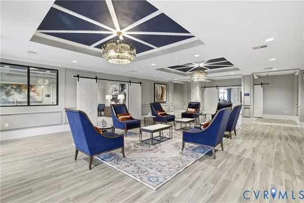 a living room with lots of furniture and view of kitchen