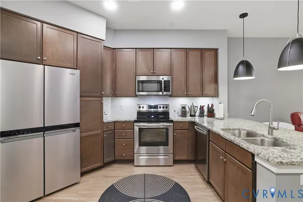 a kitchen with a sink stainless steel appliances and cabinets