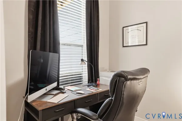 a view of a workspace with furniture and lamp