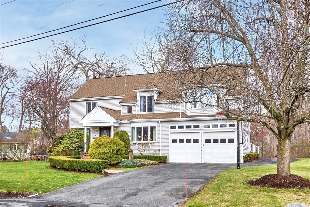 8 Peachtree Road Lexington, MA 02420 - Photo 1 of 1 a front view of a house with a yard and garage