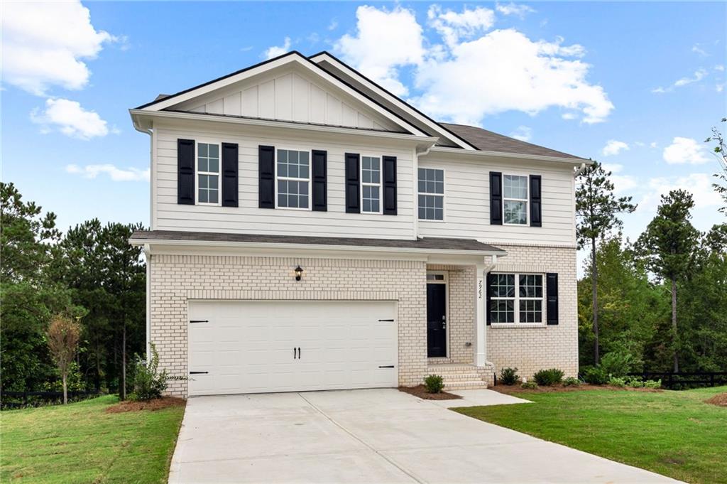 a view of a white house with yard