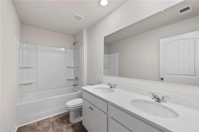 a bathroom with a toilet sink a bathtub and a vanity