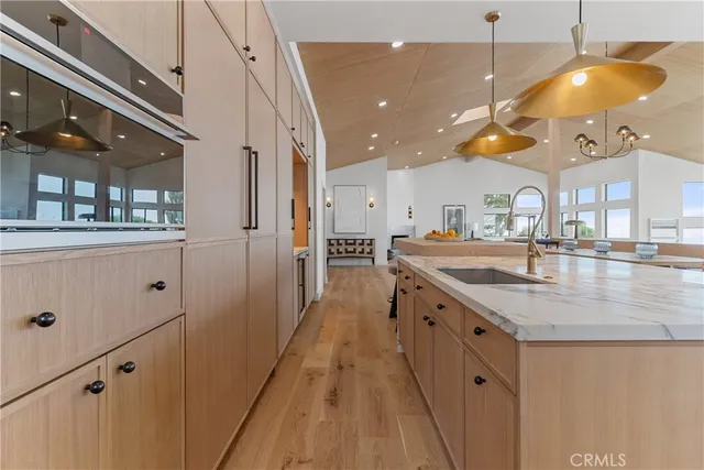 a kitchen with stainless steel appliances granite countertop a sink a stove and a refrigerator