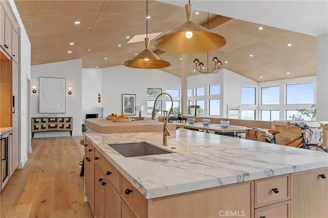 a kitchen with center island a counter space a sink and appliances