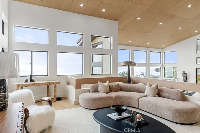 a living room with furniture and large windows