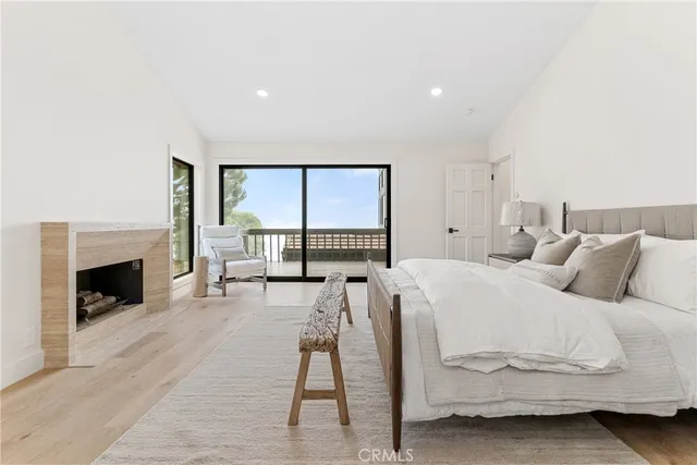 a large bedroom with a bed and a fireplace