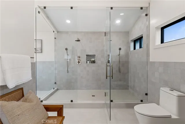 a bathroom with a bathtub shower sink vanity and toilet