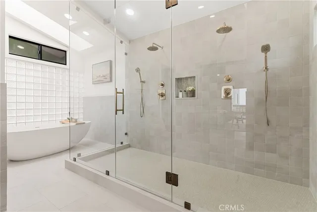 a bathroom with a bathtub and a shower