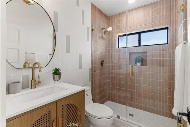 a front view of a house with a garden and trees