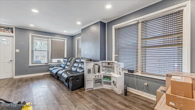 a living room with furniture window and wooden floor