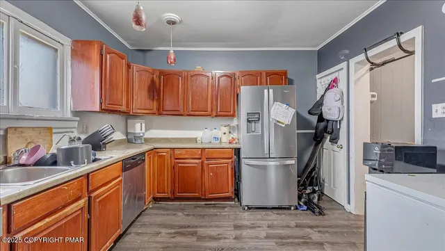a kitchen with stainless steel appliances granite countertop a refrigerator and a sink