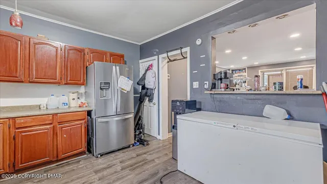 a kitchen with a refrigerator sink and cabinets