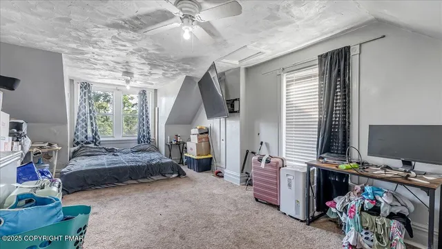 a bedroom with furniture and a window