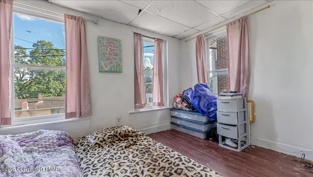 a bedroom with furniture and a window