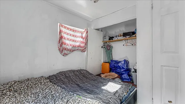a bedroom with a bed and a window