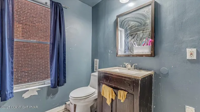 a bathroom with a toilet sink and mirror