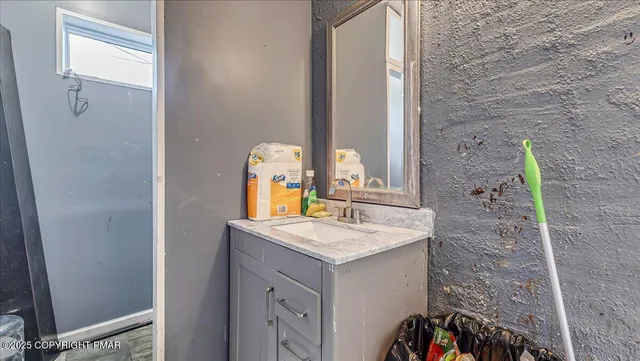 a bathroom with a sink vanity and a mirror