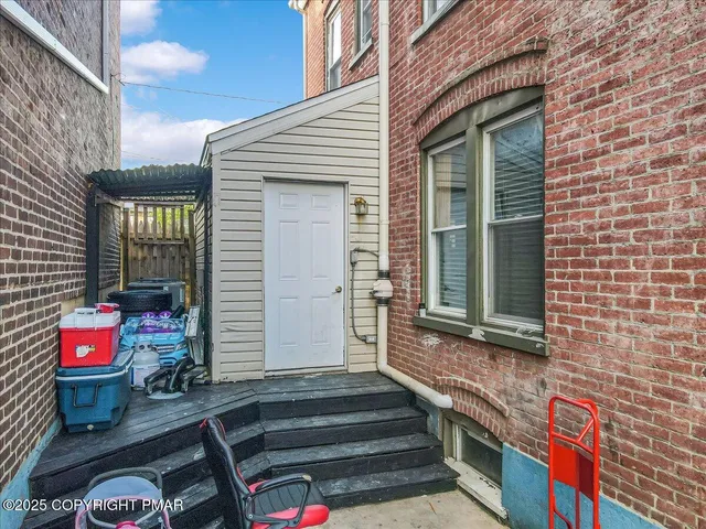 an aerial view of a house with a garden and trees