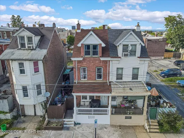 a view of a brick house with many windows
