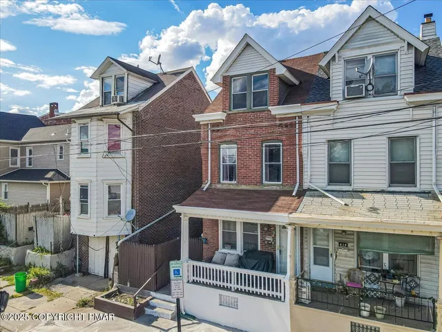 a view of a white building with large windows
