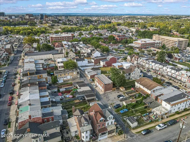 an aerial view of multiple houses with yard