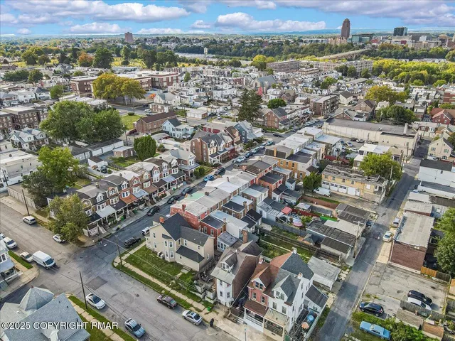 an aerial view of a houses with a yard