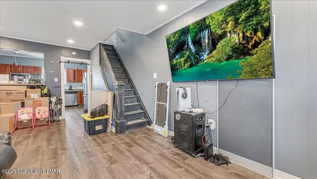 a view of entryway with wooden floor and stairs