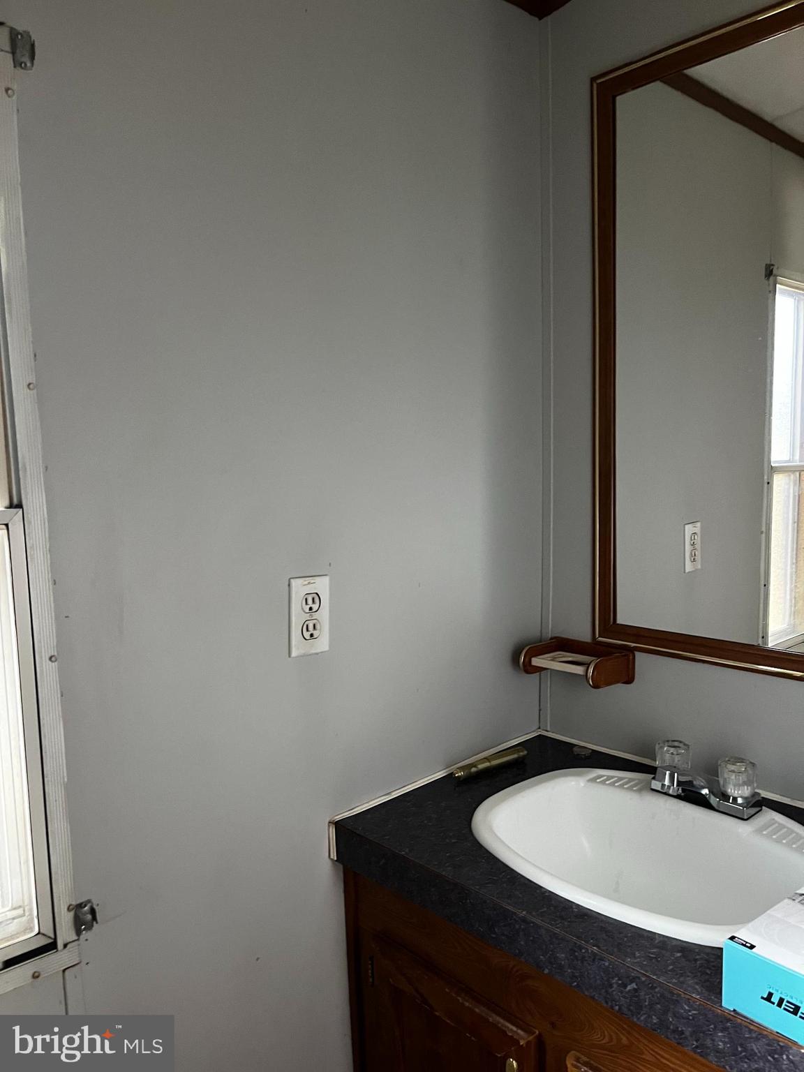 11248 Curt Dogg Road Lincoln, DE 19960 - Photo 8 of 18 a bathroom with a granite countertop sink and a mirror