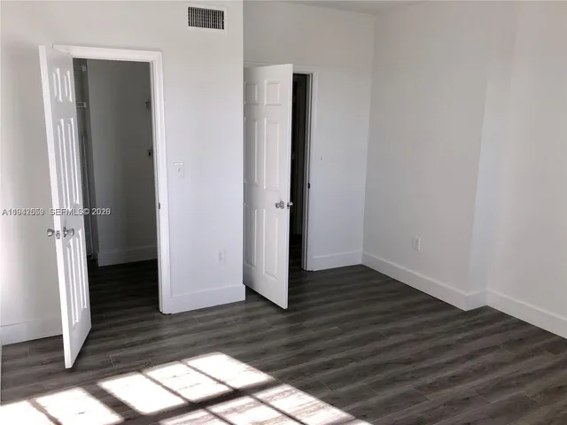 a view of wooden floor in an empty room