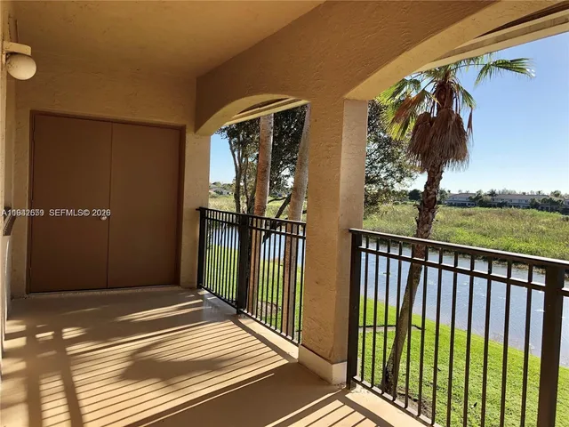 a view of a balcony with wooden floor