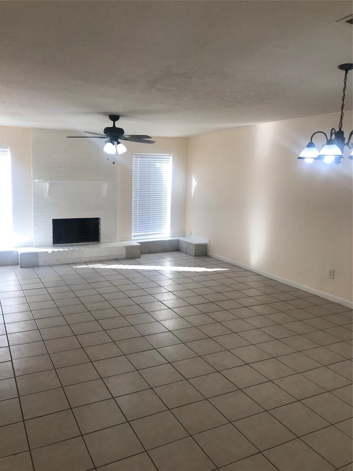 8646 Maplecrest Drive Houston, TX 77099 - Photo 2 of 13 a view of an empty room and a chandelier fan