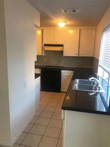 a kitchen with a stove and a refrigerator