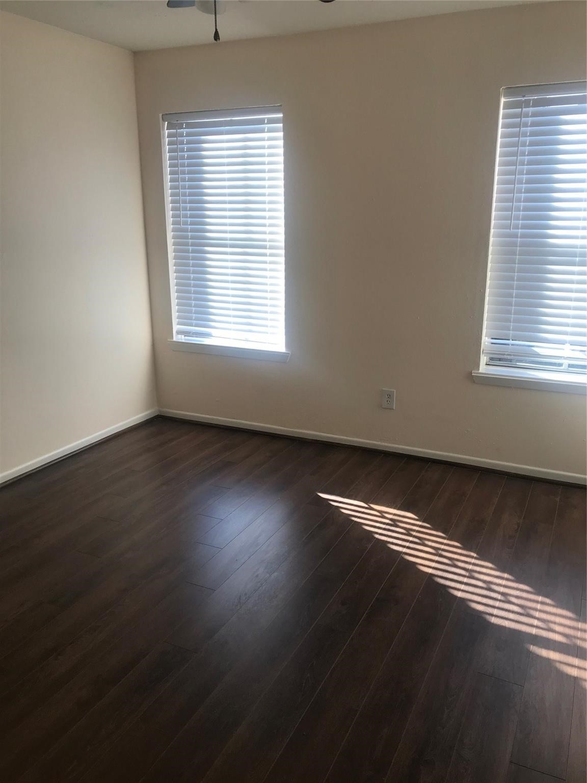 8646 Maplecrest Drive Houston, TX 77099 - Photo 8 of 13 an empty room with wooden floor and windows