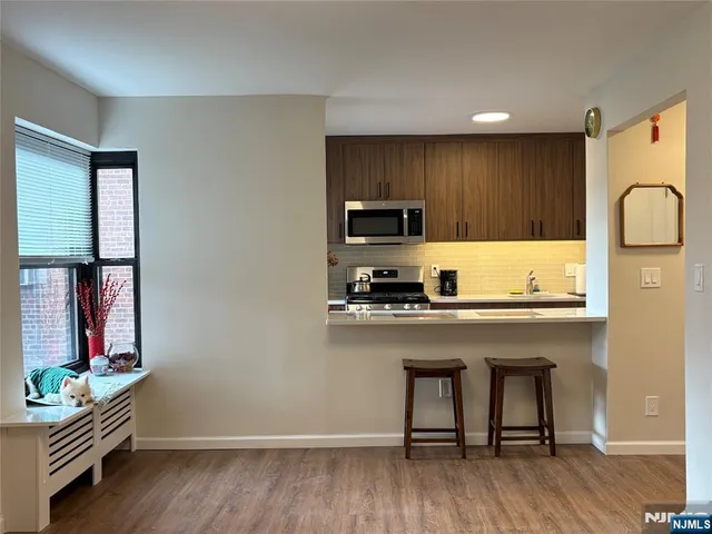 a view of a closet with wooden floor