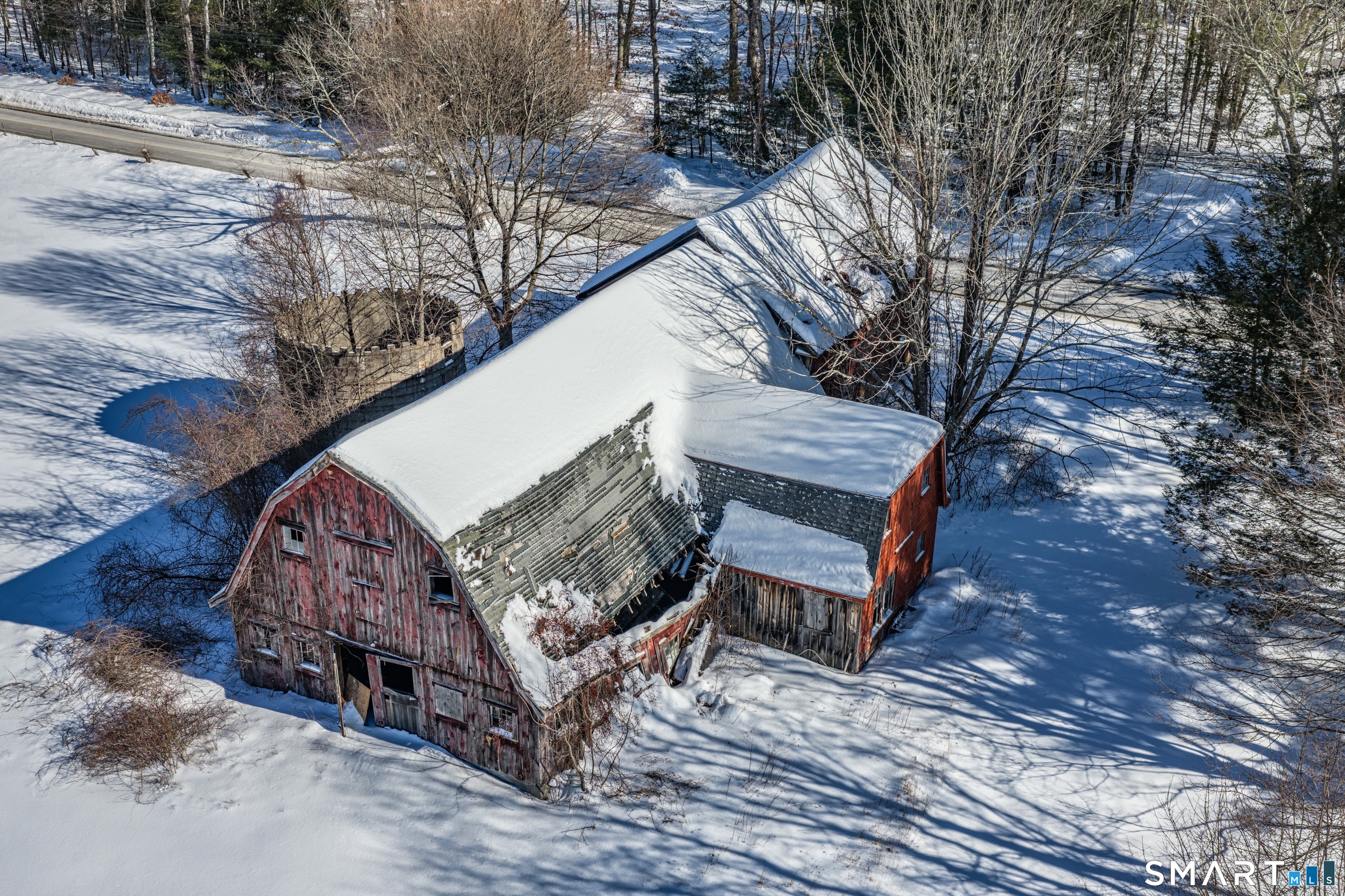 78 East Putnam Road Putnam, CT 06260 - Photo 23 of 26 a view of a house with a yard covered with snow in the background