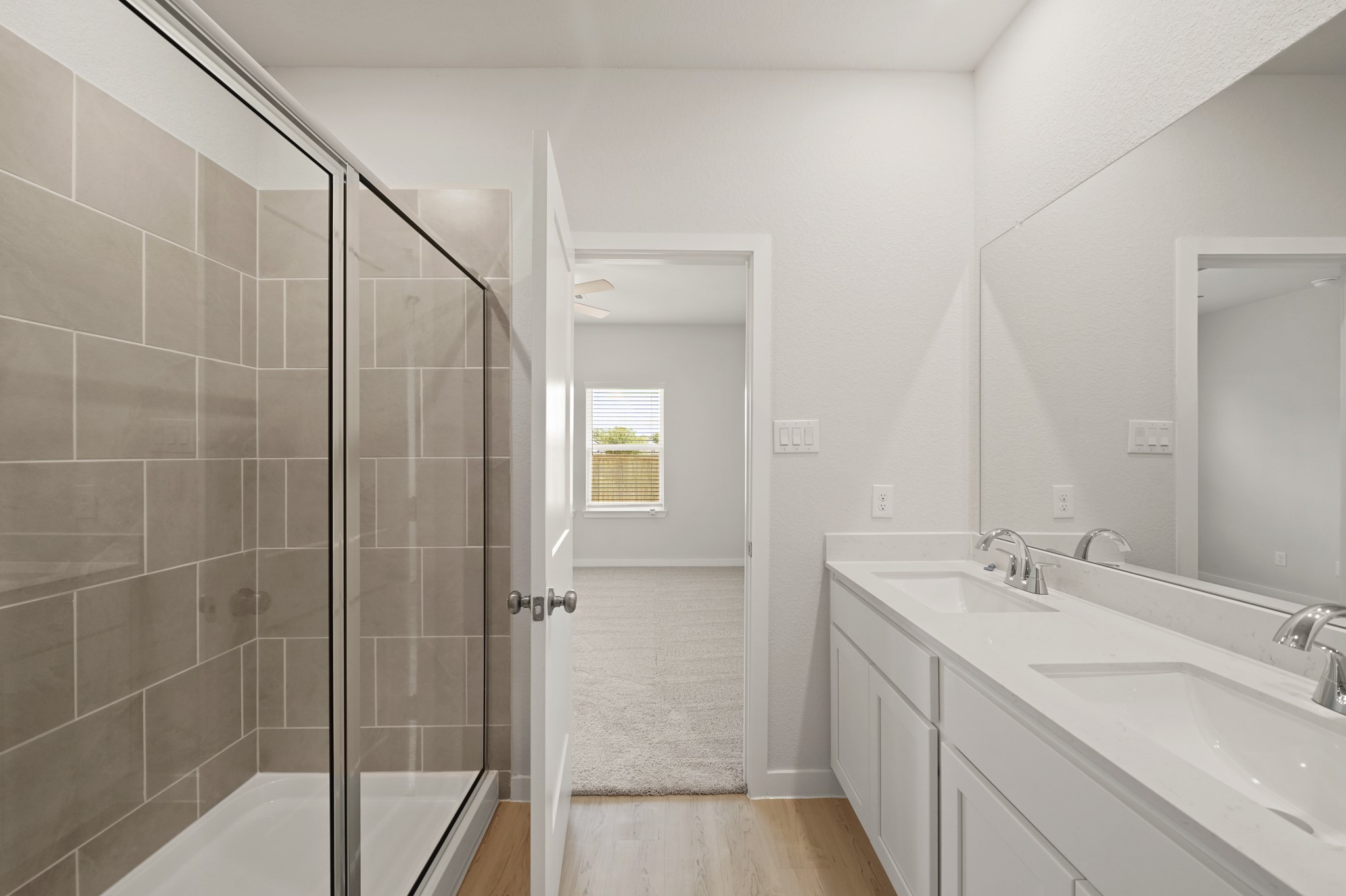 2402 Forshire Road Conroe, TX 77306 - Photo 13 of 24 a bathroom with a double vanity sink and mirror