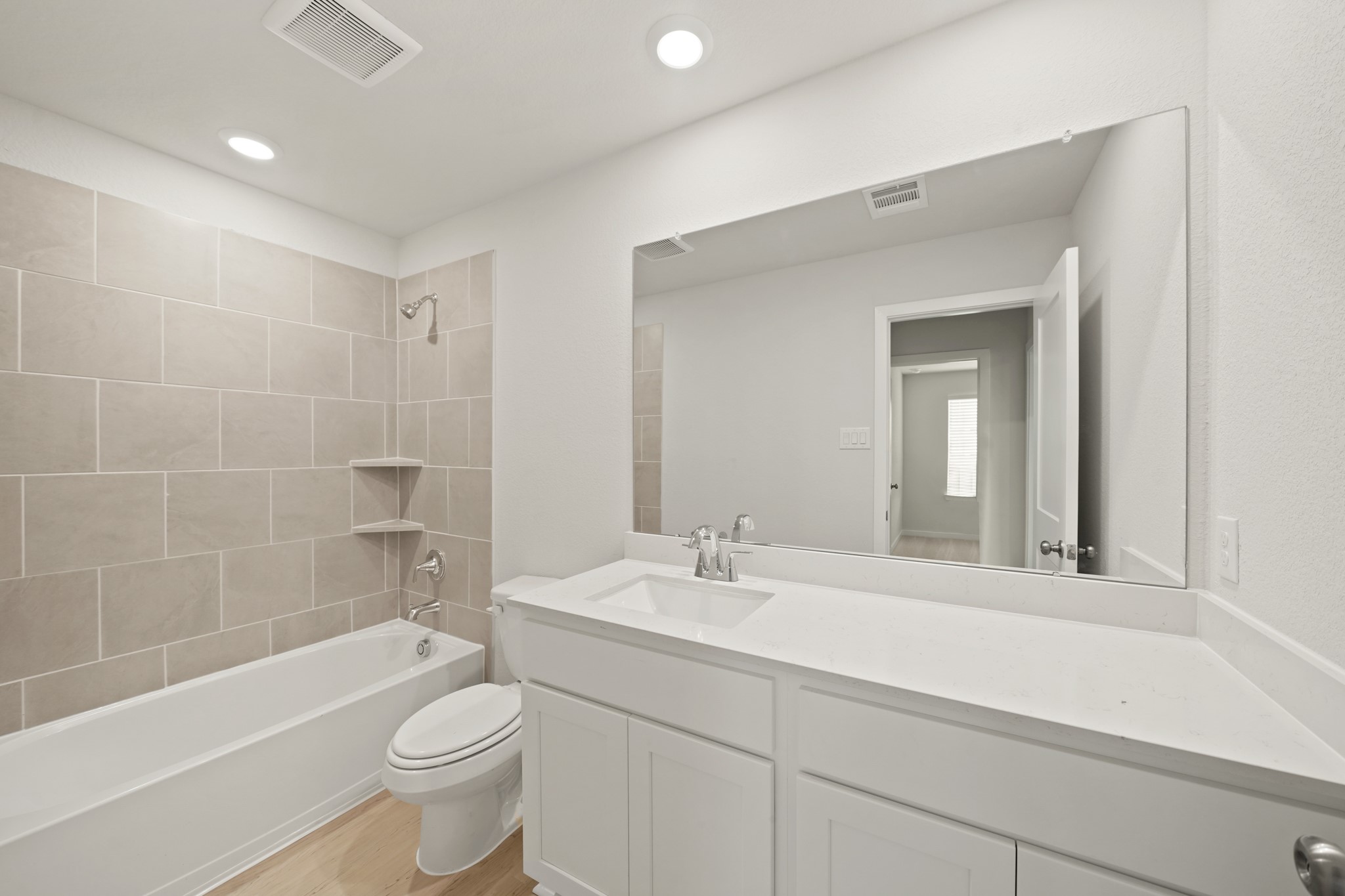 2402 Forshire Road Conroe, TX 77306 - Photo 16 of 24 a bathroom with a sink a toilet a mirror a bathtub and shower