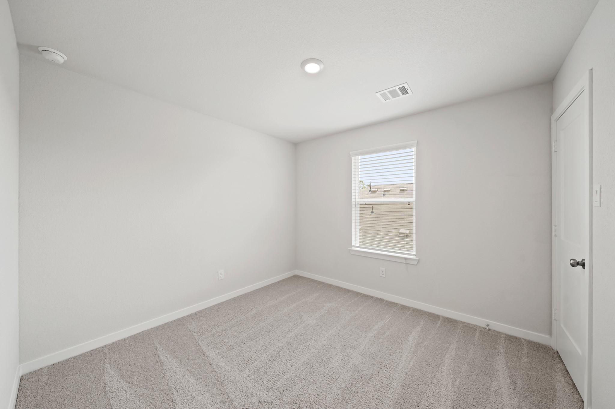 2402 Forshire Road Conroe, TX 77306 - Photo 17 of 24 a view of an empty room with a window
