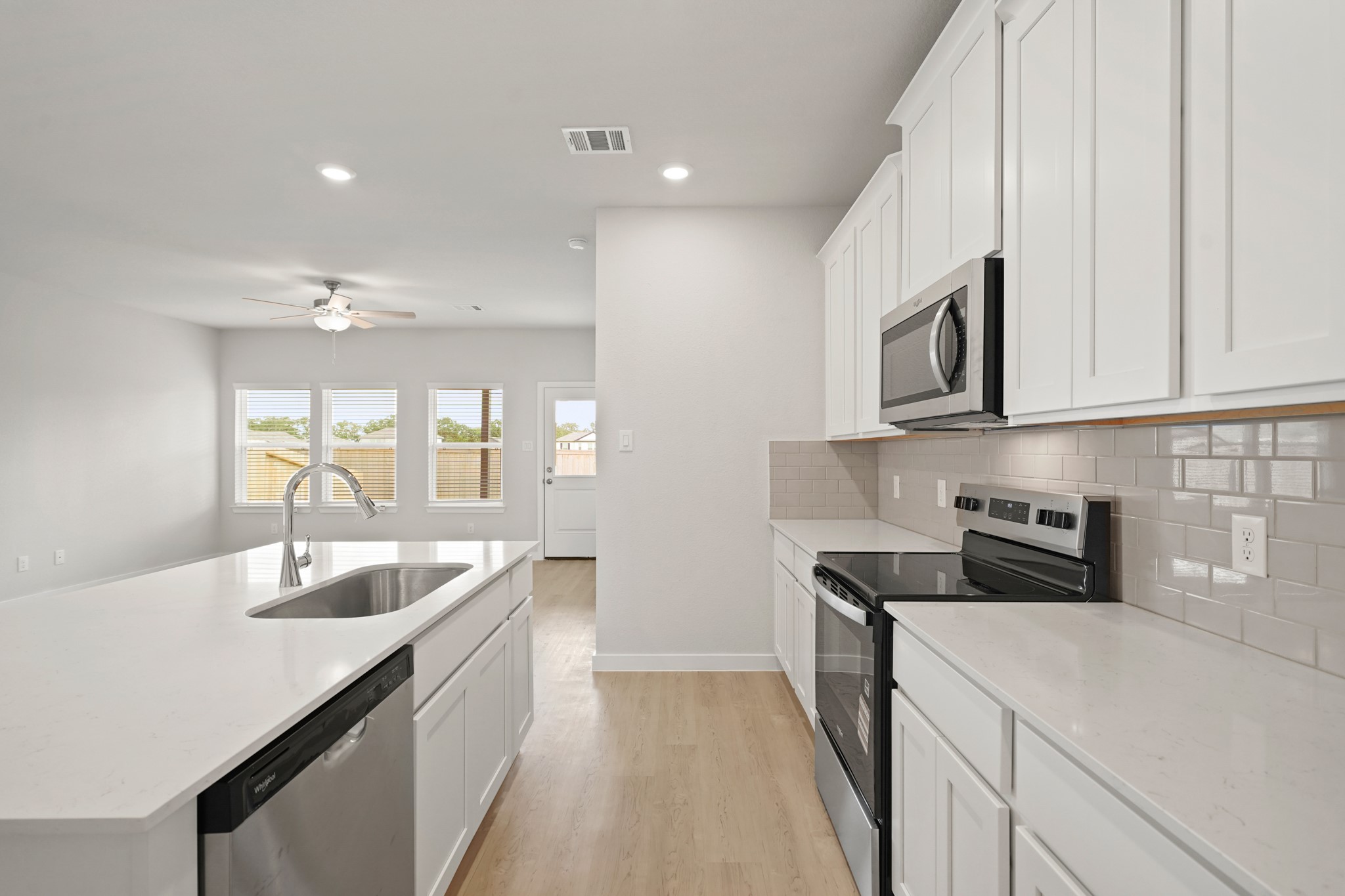 2402 Forshire Road Conroe, TX 77306 - Photo 8 of 24 a kitchen with granite countertop a sink and cabinets