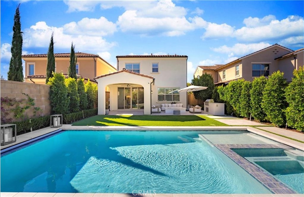 a view of pool with umbrella and wooden fence