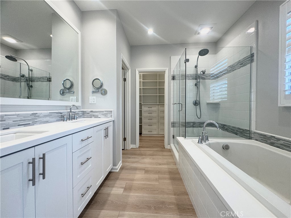 179 Hargrove Irvine, CA 92620 - Photo 11 of 27 a spacious bathroom with a bathtub shower sink double and mirror