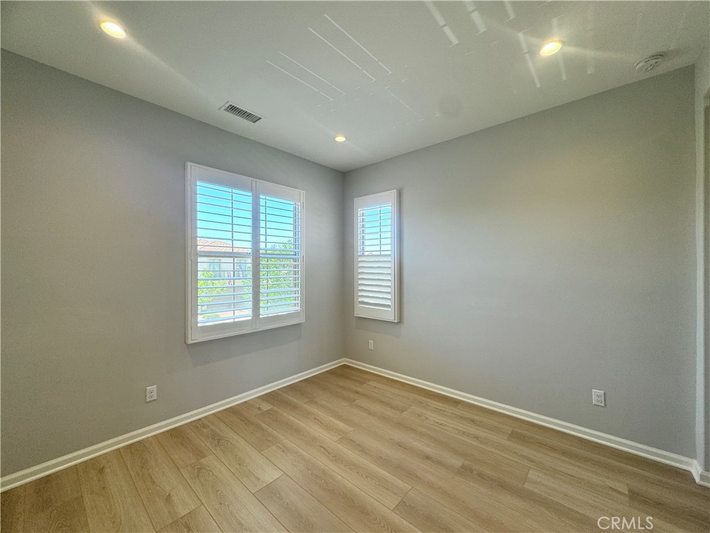 179 Hargrove Irvine, CA 92620 - Photo 16 of 27 an empty room with wooden floor and windows