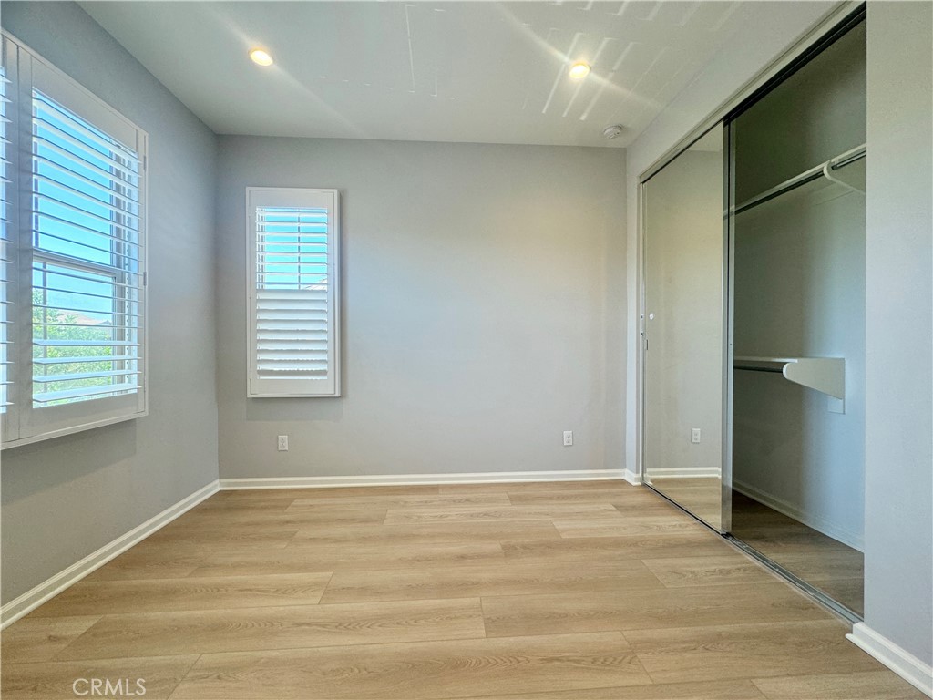 179 Hargrove Irvine, CA 92620 - Photo 17 of 27 a view of an empty room with wooden floor and a window