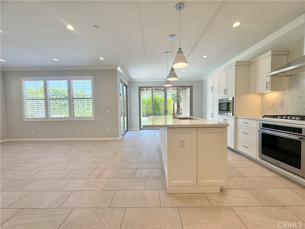 179 Hargrove Irvine, CA 92620 - Photo 4 of 27 a kitchen with granite countertop a stove a sink and a refrigerator