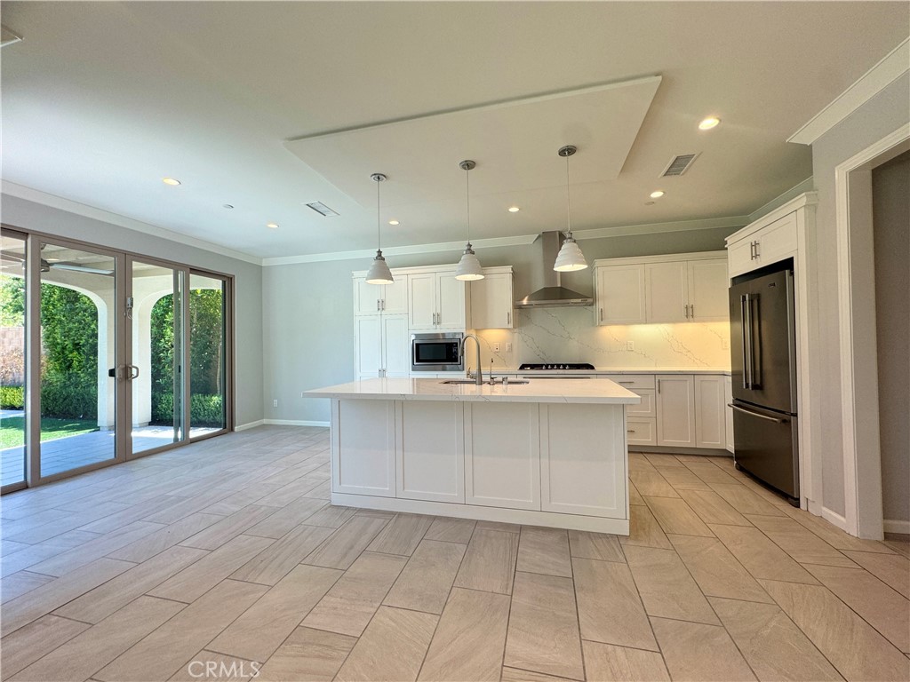 179 Hargrove Irvine, CA 92620 - Photo 5 of 27 a large white kitchen with a large window and stainless steel appliances
