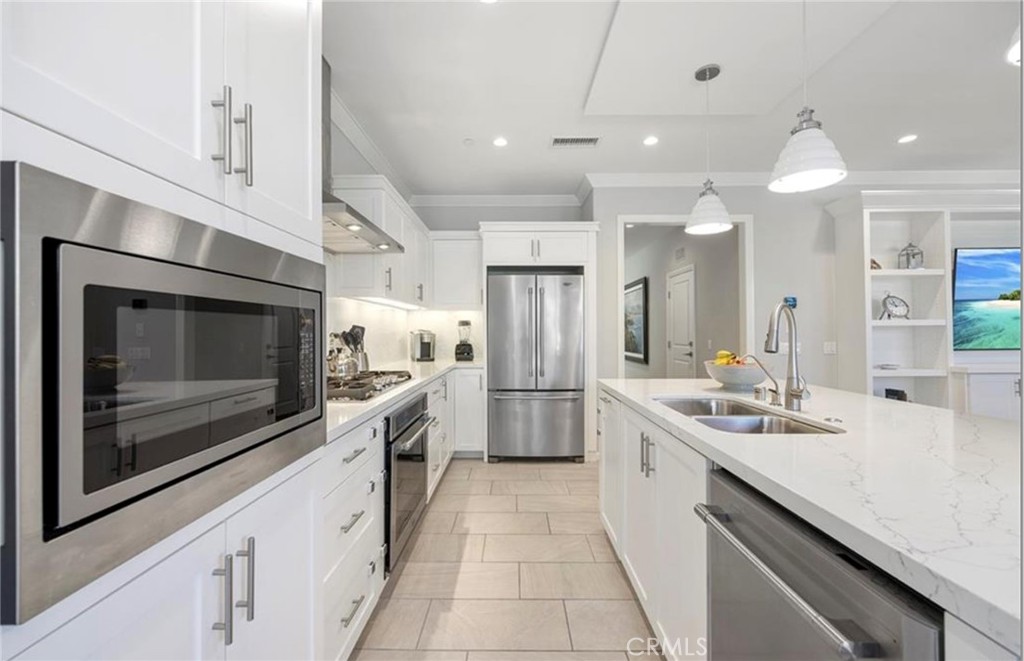 179 Hargrove Irvine, CA 92620 - Photo 6 of 27 a large white kitchen with stainless steel appliances
