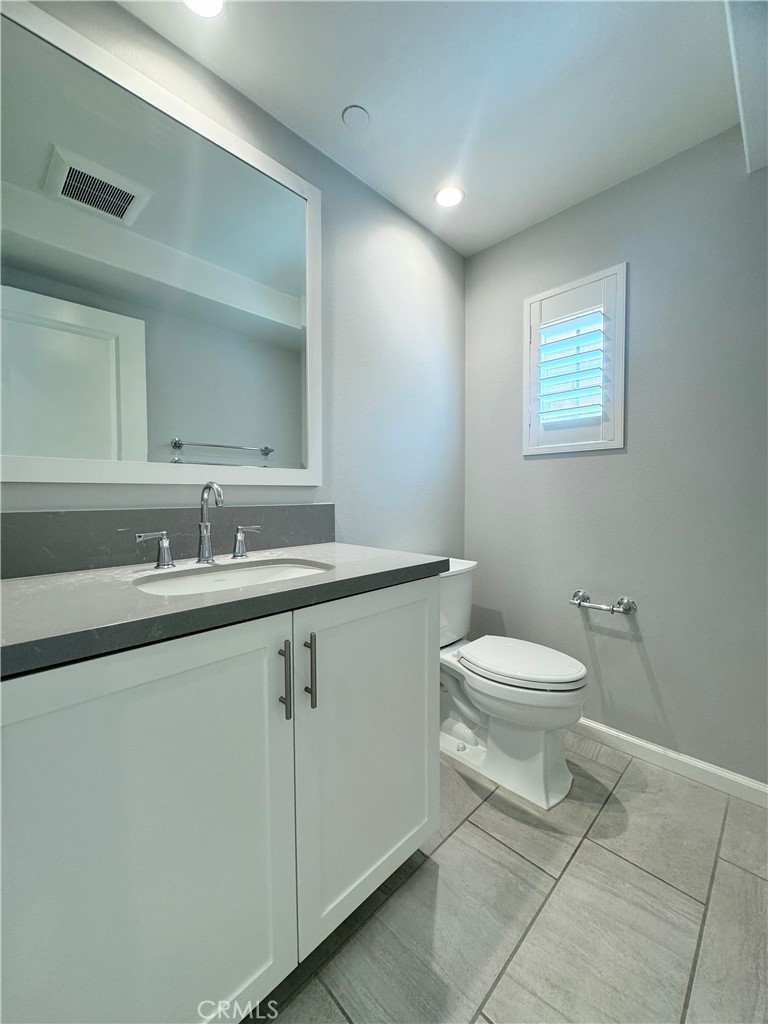179 Hargrove Irvine, CA 92620 - Photo 9 of 27 a bathroom with a toilet a sink and mirror