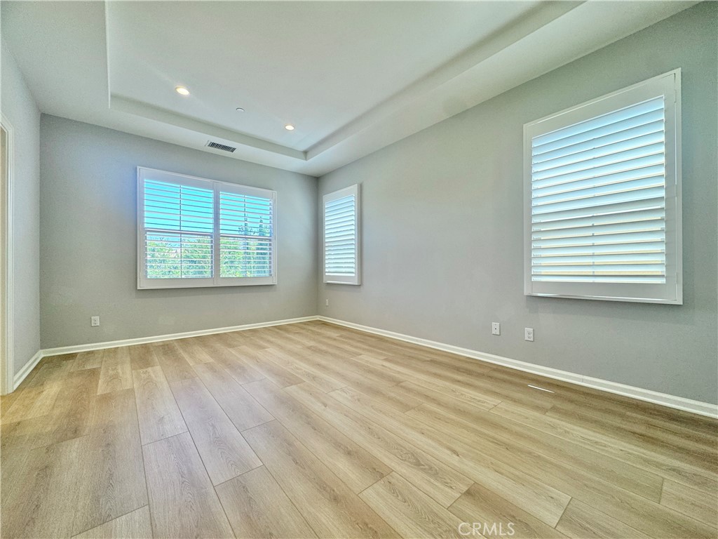 179 Hargrove Irvine, CA 92620 - Photo 10 of 27 an empty room with wooden floor and windows