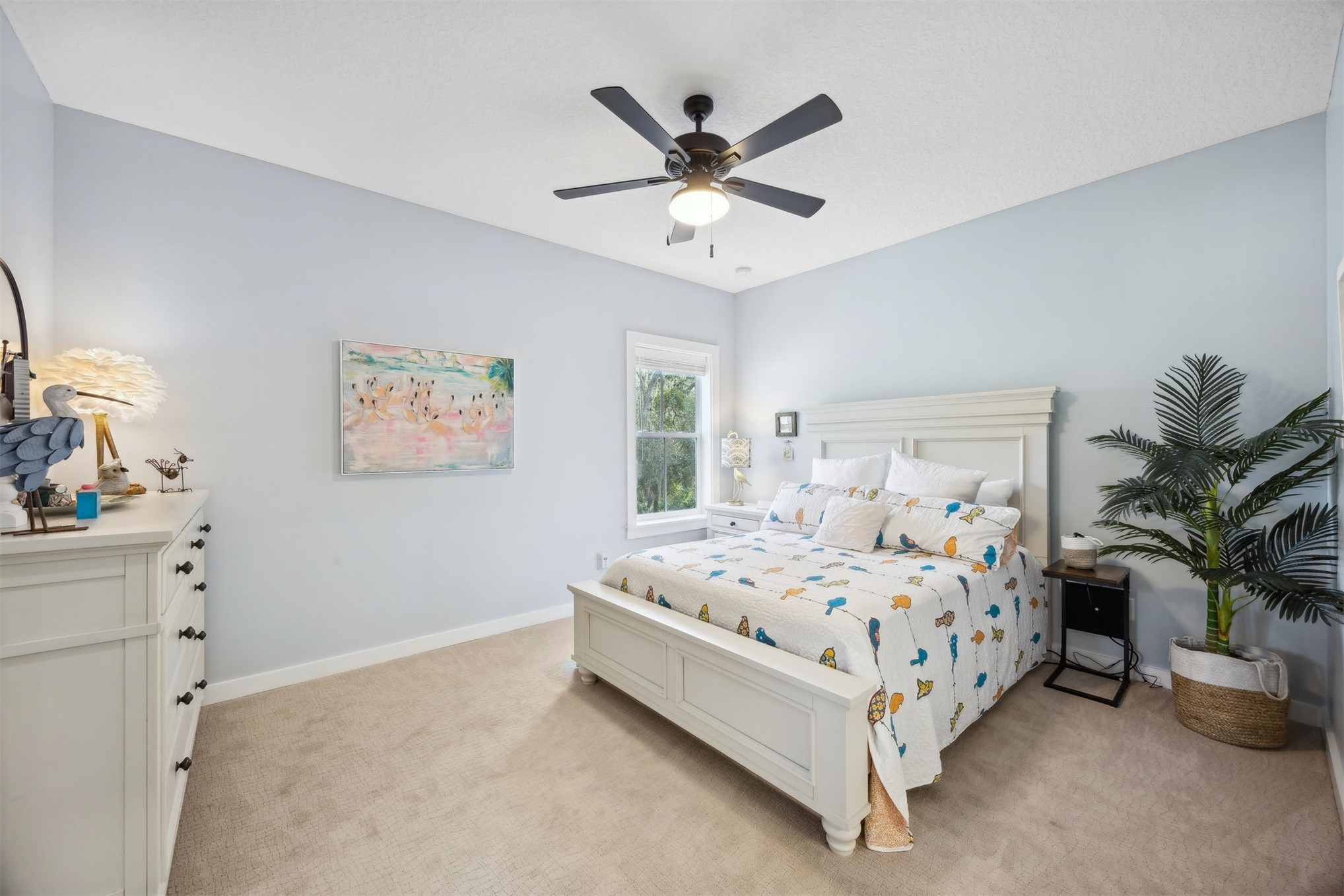 45 Beachwood Road Amelia Island, FL 32034 - Photo 21 of 41 a bed sitting in a bedroom next to a window and a chandelier