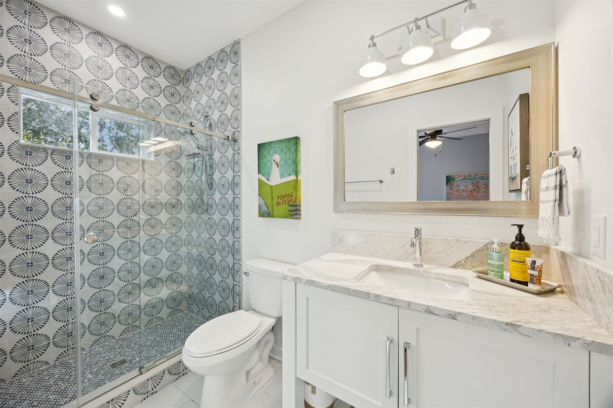45 Beachwood Road Amelia Island, FL 32034 - Photo 22 of 41 a bathroom with a granite countertop sink a toilet and a mirror